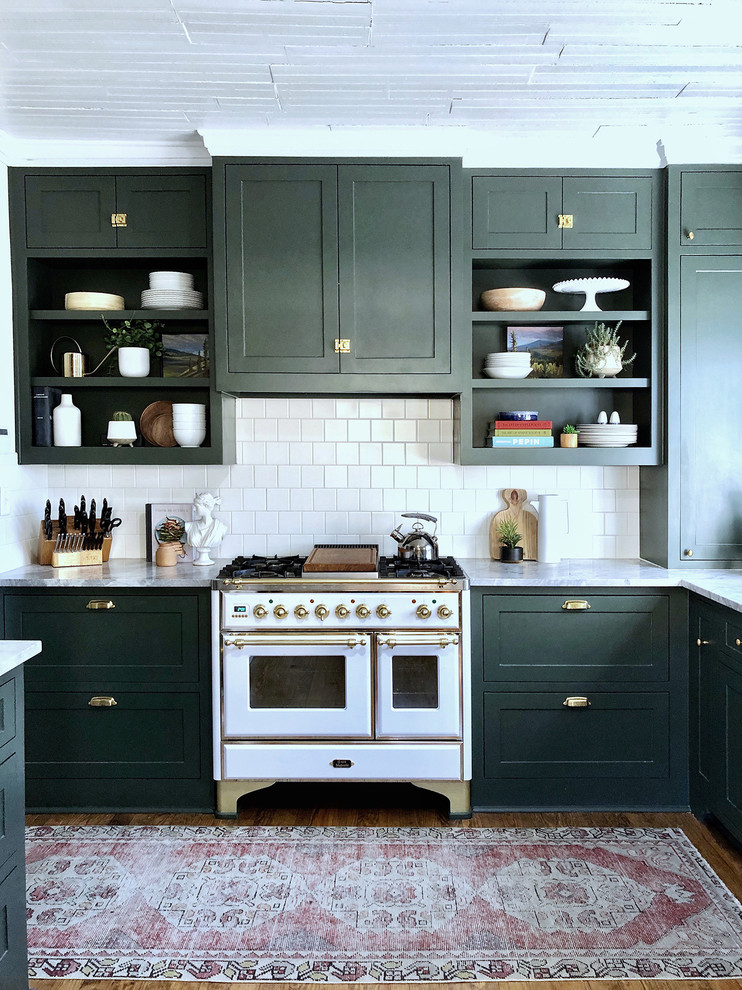 Small classic l-shaped enclosed kitchen in Dallas with shaker cabinets, green cabinets, white splashback and dark hardwood flooring.