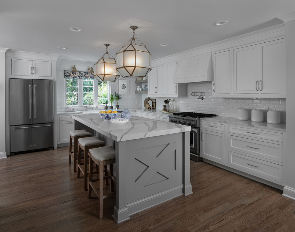 Eat-in kitchen - large transitional l-shaped light wood floor and brown floor eat-in kitchen idea in Detroit with a farmhouse sink, flat-panel cabinets, white cabinets, quartz countertops, white backsplash, ceramic backsplash, stainless steel appliances, an island and gray countertops