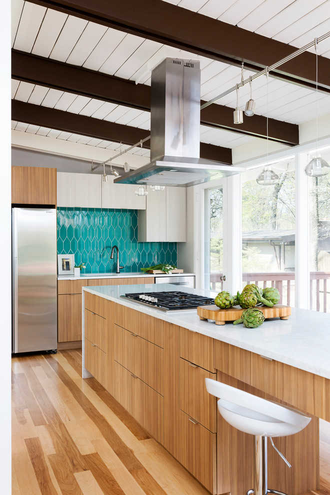 Example of a large trendy medium tone wood floor open concept kitchen design in DC Metro with flat-panel cabinets, medium tone wood cabinets, blue backsplash, stainless steel appliances and an island