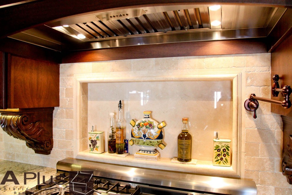 Eat-in kitchen - large traditional l-shaped travertine floor eat-in kitchen idea in Orange County with a farmhouse sink, recessed-panel cabinets, dark wood cabinets, granite countertops, beige backsplash, subway tile backsplash, stainless steel appliances and an island