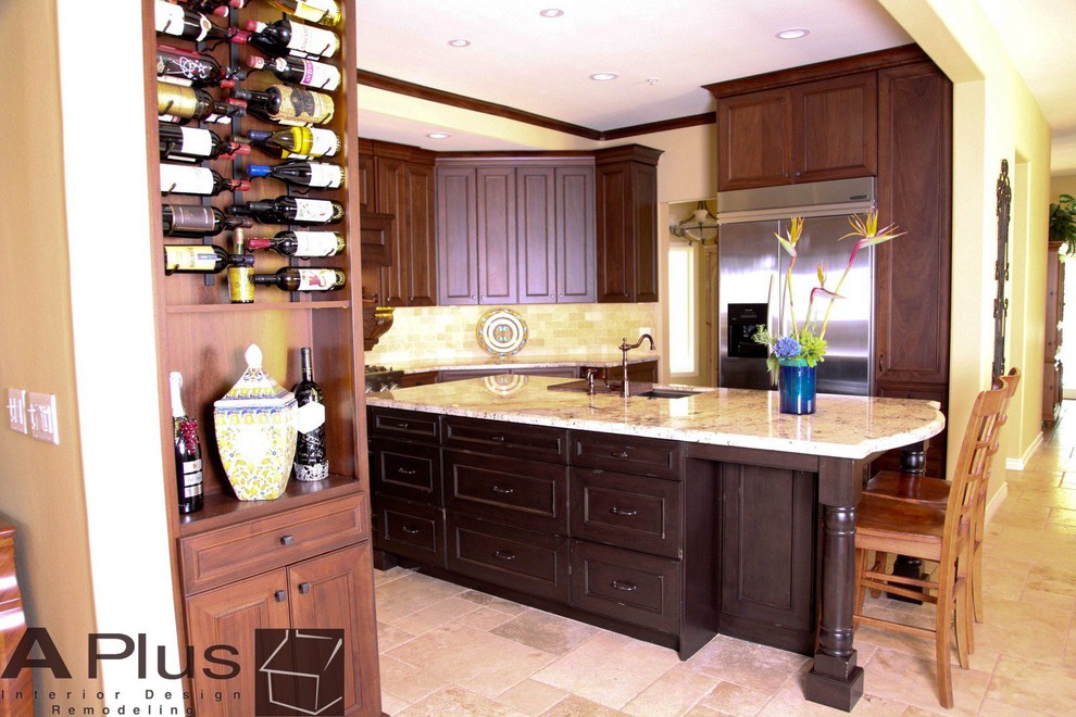 Large l-shaped travertine floor eat-in kitchen photo in Orange County with a drop-in sink, recessed-panel cabinets, dark wood cabinets, granite countertops, beige backsplash, subway tile backsplash, stainless steel appliances and an island