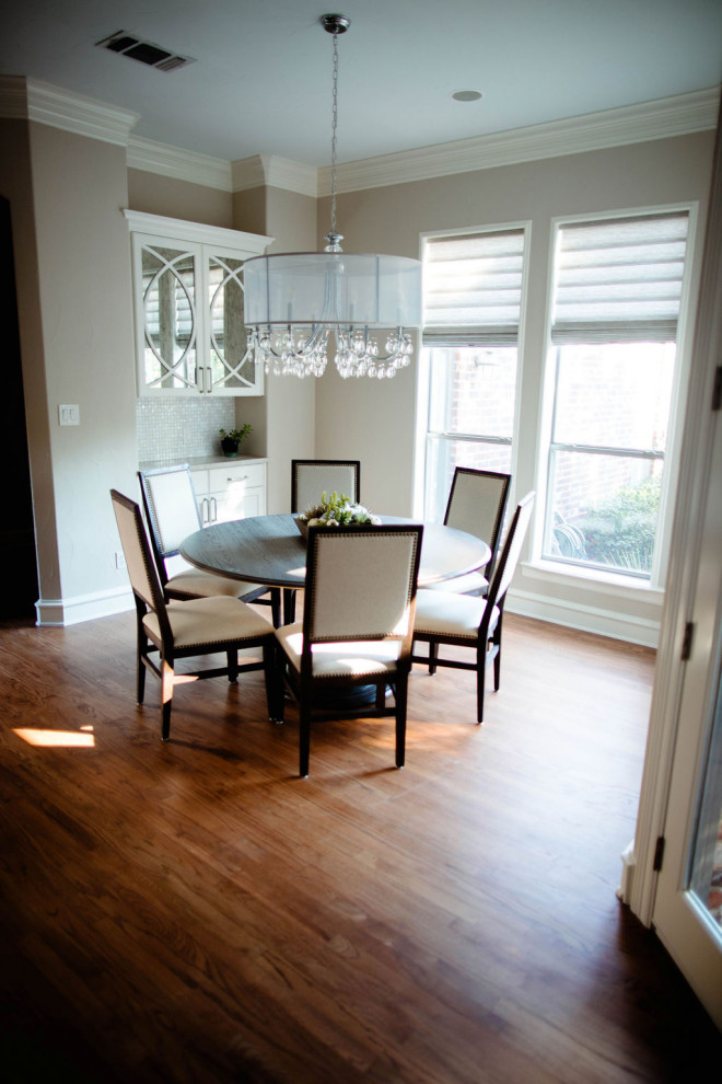 This is an example of a large classic open plan dining room in Dallas with medium hardwood flooring and brown floors.