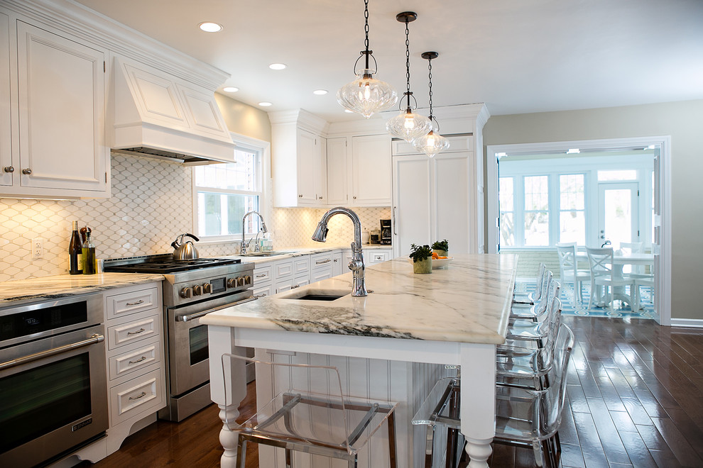 Large transitional medium tone wood floor eat-in kitchen photo in Other with white cabinets, marble countertops, multicolored backsplash, paneled appliances and two islands