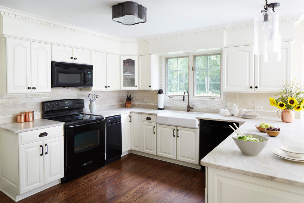 Kitchen - traditional u-shaped dark wood floor and brown floor kitchen idea in Chicago with a farmhouse sink, raised-panel cabinets, white cabinets, beige backsplash, subway tile backsplash and black appliances