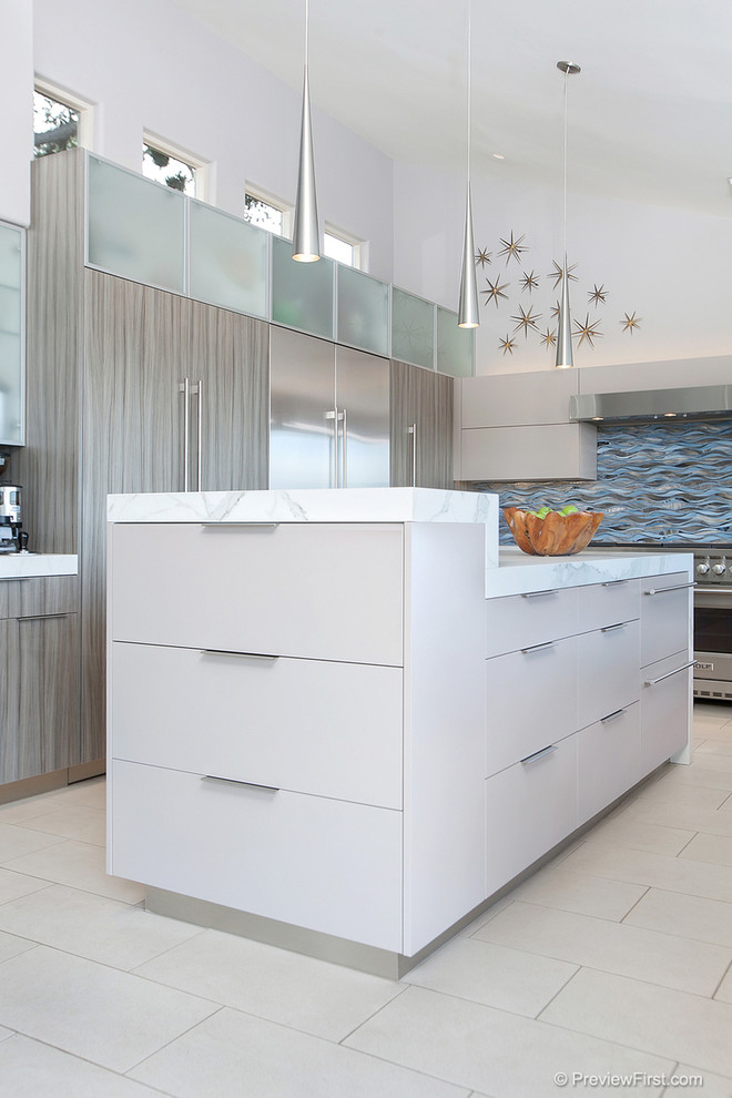 Photo of a large contemporary u-shaped open plan kitchen in San Diego with a submerged sink, flat-panel cabinets, grey cabinets, tile countertops, blue splashback, glass tiled splashback, stainless steel appliances, porcelain flooring and an island.