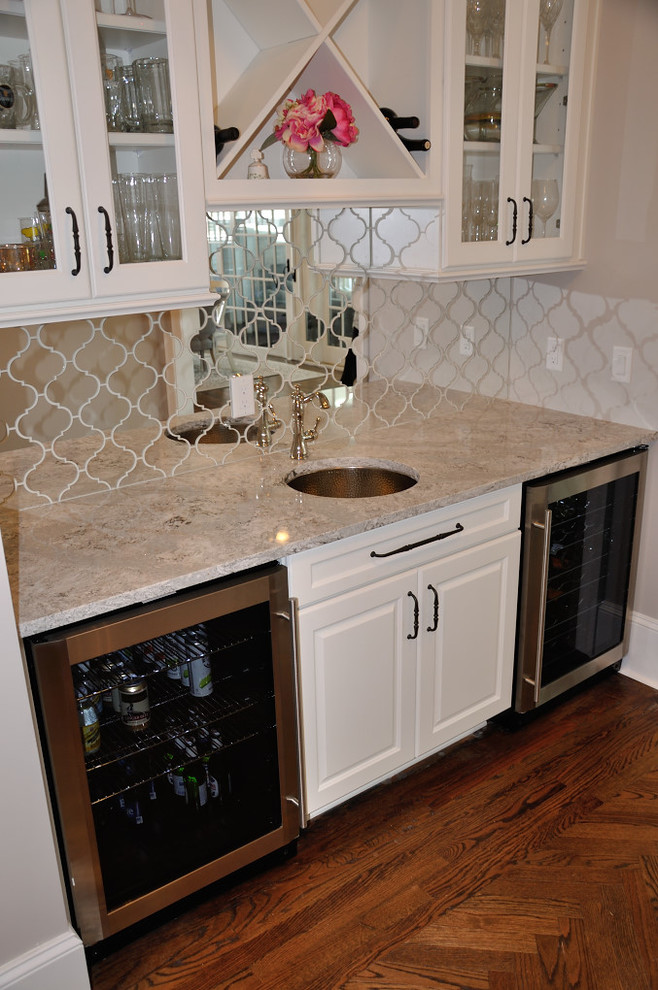 Transitional medium tone wood floor kitchen photo with quartz countertops, ceramic backsplash and stainless steel appliances