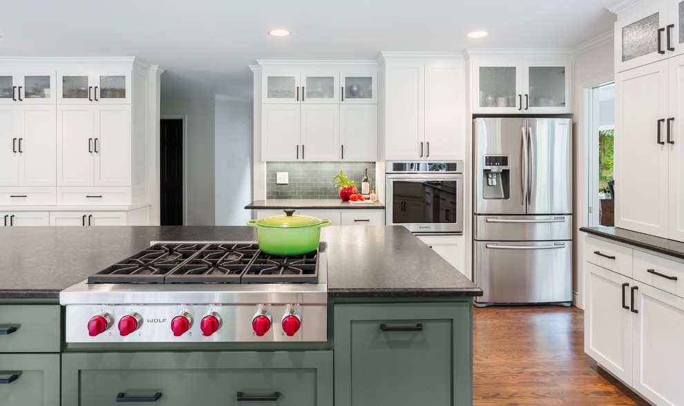 Inspiration for a medium sized classic kitchen in Seattle with shaker cabinets, soapstone worktops, green splashback, ceramic splashback, stainless steel appliances, an island, brown floors, white cabinets and dark hardwood flooring.