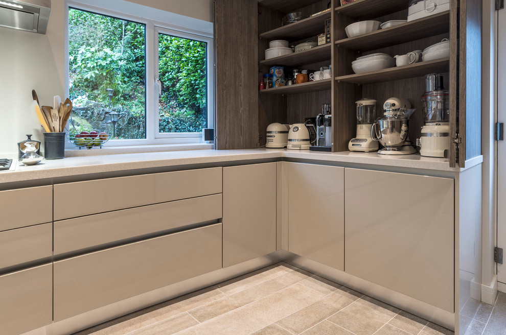 Photo of a modern kitchen/diner in Cheshire with flat-panel cabinets, white cabinets, marble worktops and white appliances.