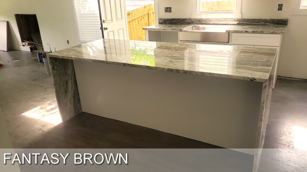 Large modern galley kitchen in Atlanta with a submerged sink, recessed-panel cabinets, white cabinets, marble worktops, brown splashback, marble splashback, stainless steel appliances, plywood flooring, multiple islands, brown floors and brown worktops.