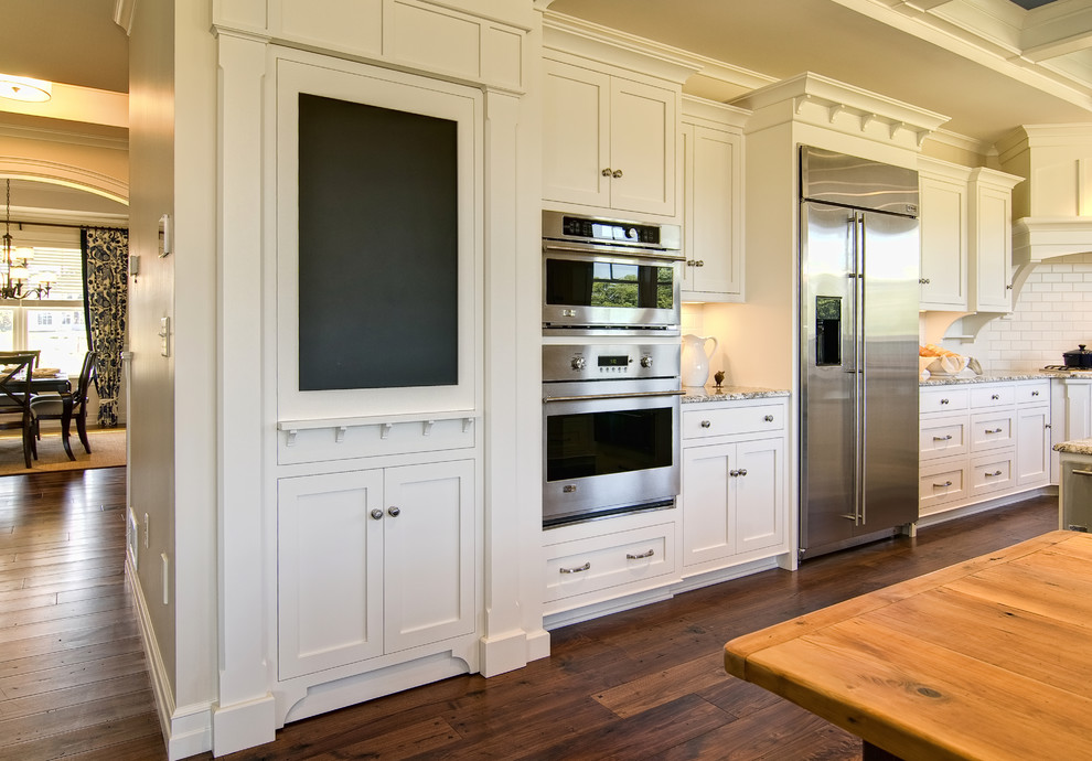 Kitchen - traditional kitchen idea in Other with stainless steel appliances and subway tile backsplash