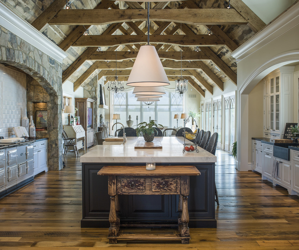 Farmhouse u-shaped dark wood floor open concept kitchen photo in Baltimore with an island, a farmhouse sink, raised-panel cabinets, white cabinets, white backsplash and subway tile backsplash