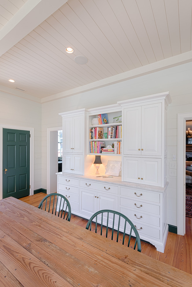 Inspiration for a large cottage single-wall medium tone wood floor eat-in kitchen remodel in Charlotte with a double-bowl sink, white cabinets, marble countertops, white backsplash, stone slab backsplash, colored appliances and no island