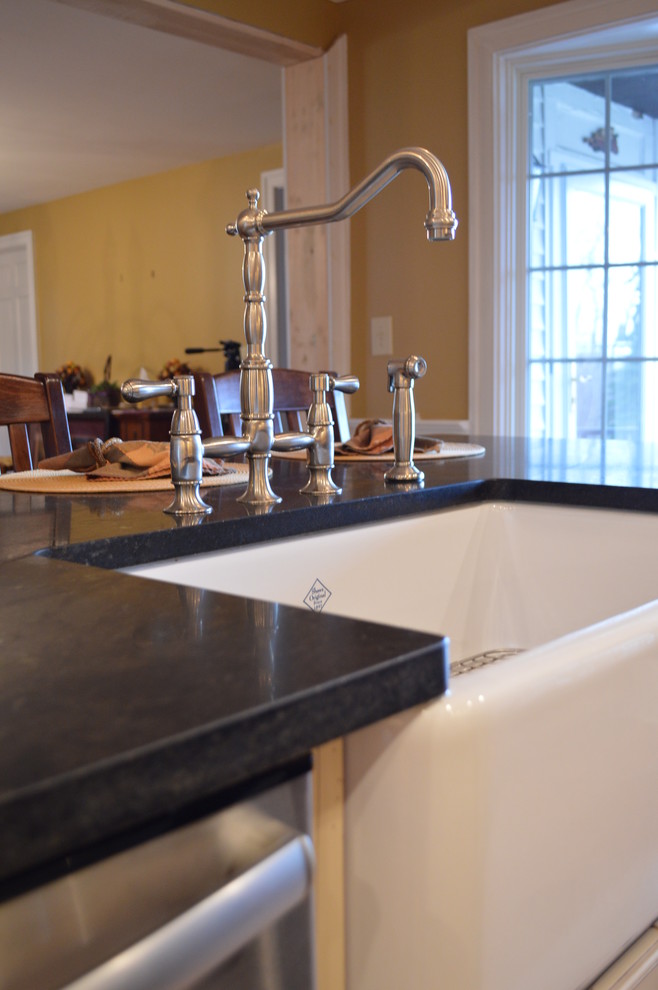 Farmhouse kitchen photo in Cleveland with a farmhouse sink and granite countertops