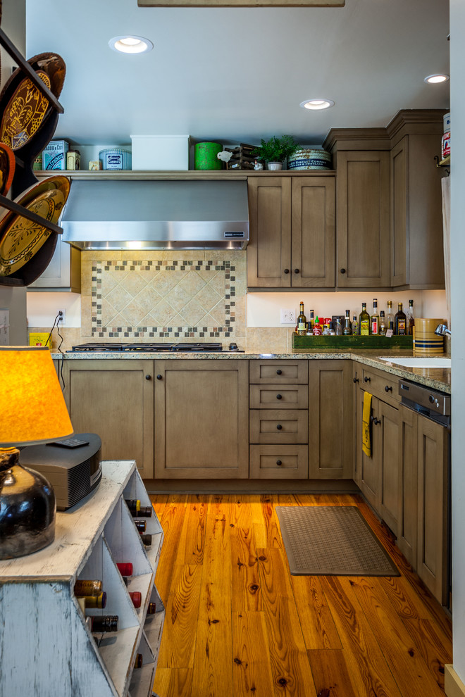 Inspiration for a large cottage u-shaped medium tone wood floor kitchen pantry remodel in Seattle with an undermount sink, recessed-panel cabinets, brown cabinets, quartz countertops, multicolored backsplash, ceramic backsplash, paneled appliances and no island