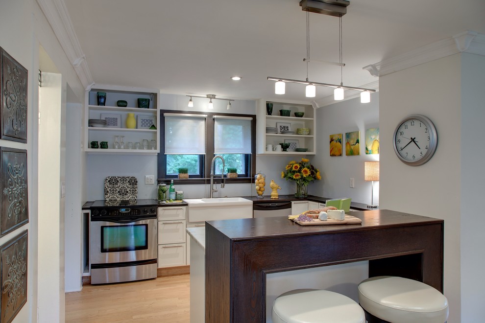 Example of a transitional u-shaped kitchen design in Bridgeport with a farmhouse sink, open cabinets, white cabinets and stainless steel appliances