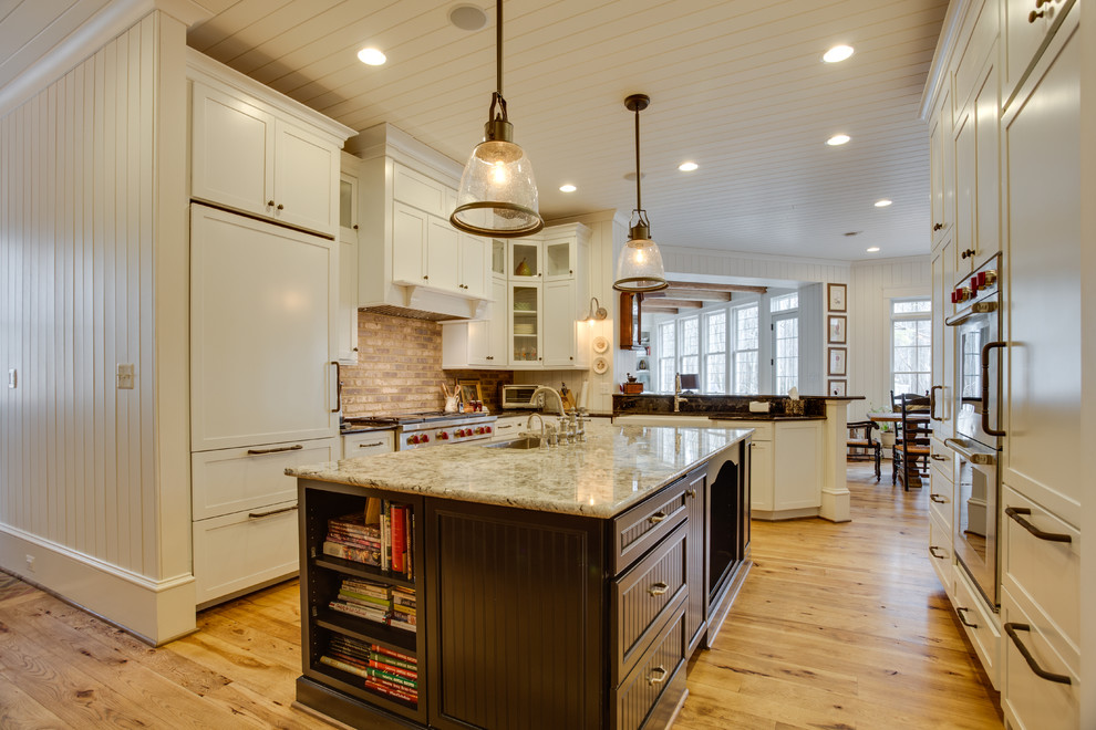 Inspiration for a large farmhouse u-shaped medium tone wood floor kitchen remodel in DC Metro with a farmhouse sink, granite countertops, stainless steel appliances and an island