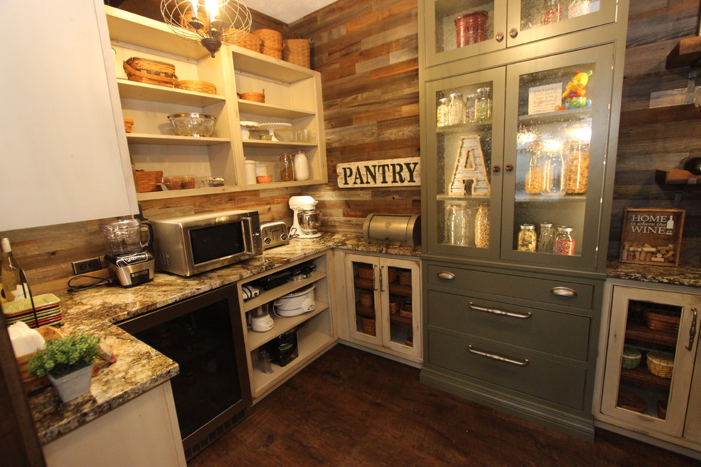 This is an example of a large farmhouse l-shaped kitchen pantry in Cleveland with a belfast sink, raised-panel cabinets, distressed cabinets, quartz worktops, grey splashback, mosaic tiled splashback, integrated appliances, dark hardwood flooring, an island, brown floors and white worktops.