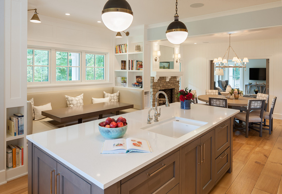 Inspiration for a large country u-shaped kitchen/diner in Grand Rapids with a submerged sink, shaker cabinets, grey cabinets, engineered stone countertops, medium hardwood flooring, an island, beige floors and white worktops.