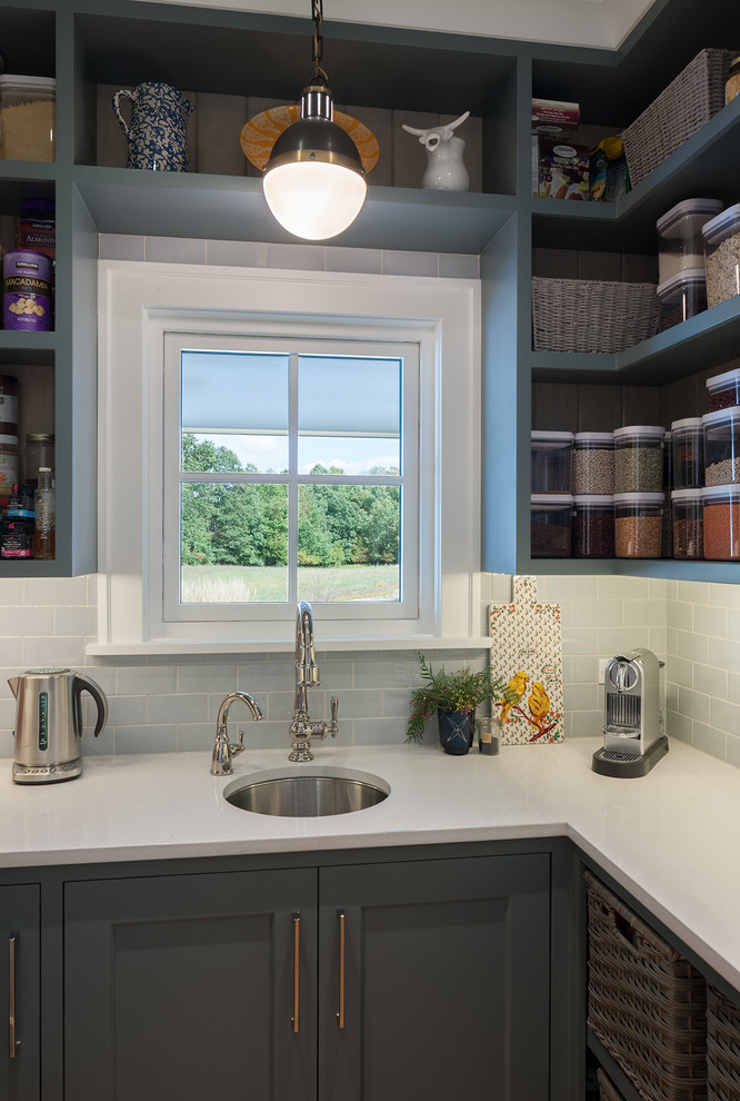 Inspiration for a small country u-shaped kitchen pantry in Grand Rapids with a submerged sink, shaker cabinets, grey cabinets, engineered stone countertops, blue splashback, metro tiled splashback, light hardwood flooring, beige floors and white worktops.