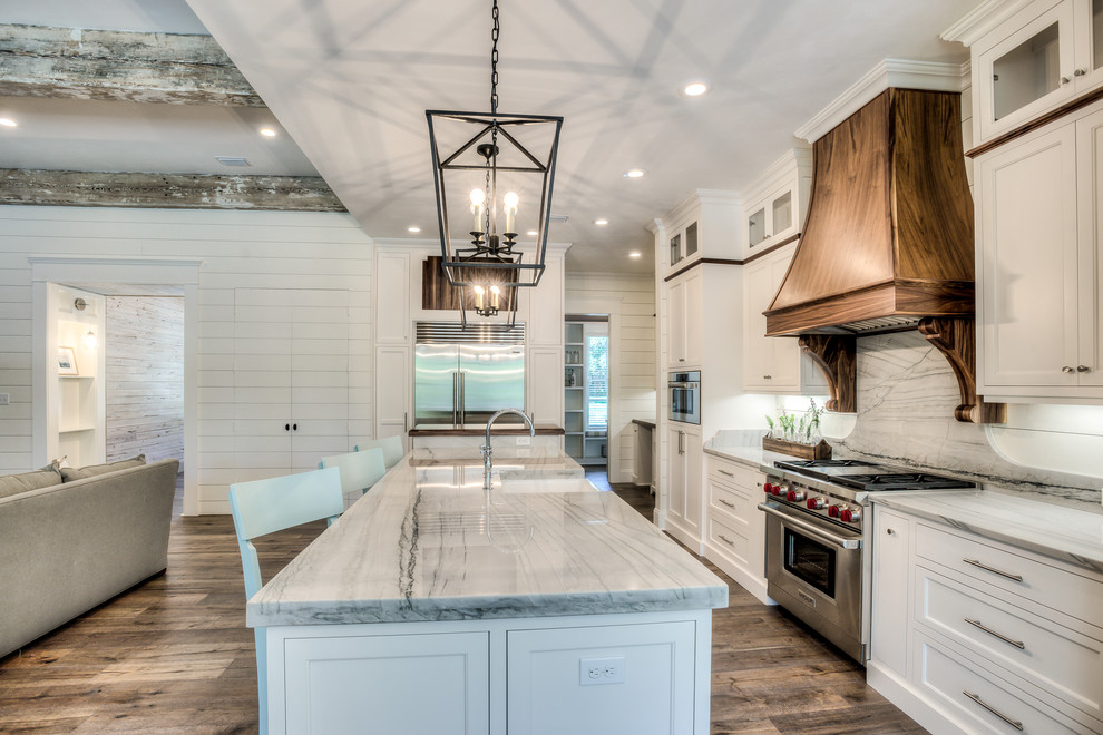 Medium sized farmhouse kitchen in Atlanta with a belfast sink, beaded cabinets, white cabinets, quartz worktops, white splashback, stainless steel appliances and an island.