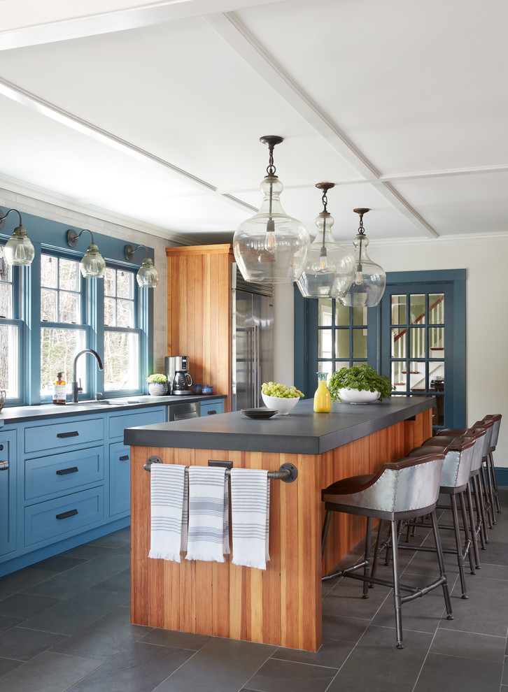 Eat-in kitchen - mid-sized farmhouse single-wall slate floor and gray floor eat-in kitchen idea in Boston with a single-bowl sink, recessed-panel cabinets, blue cabinets, limestone countertops, subway tile backsplash, stainless steel appliances, an island and white backsplash