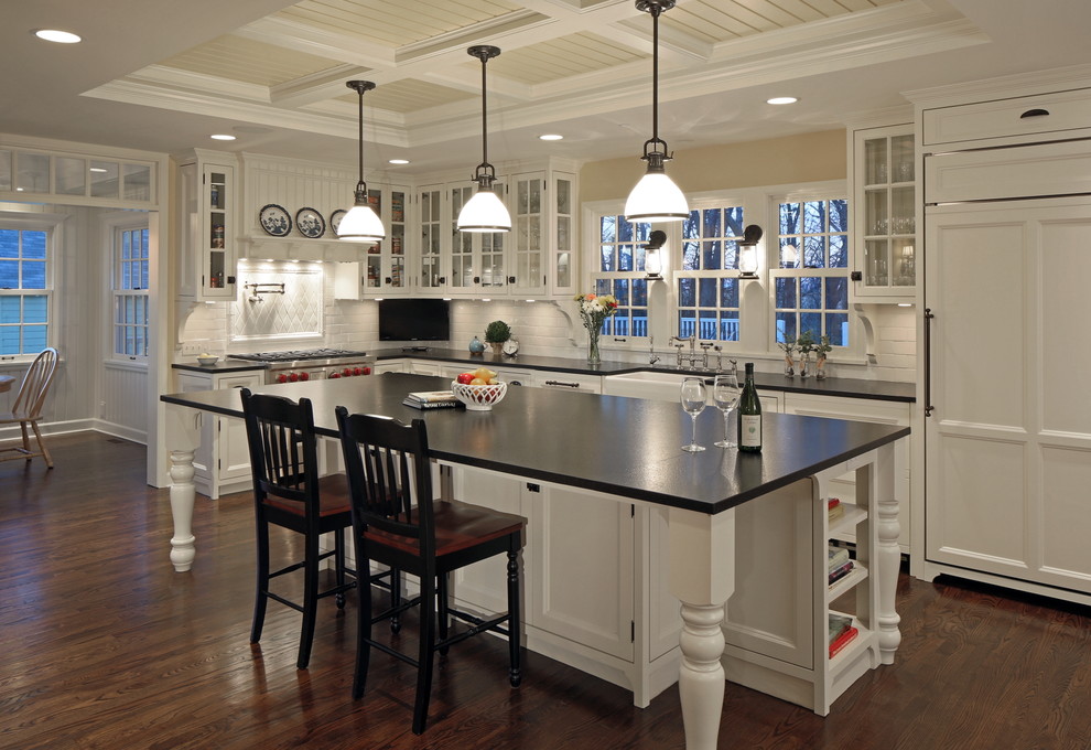 Country kitchen photo in Omaha with glass-front cabinets, white backsplash, subway tile backsplash, paneled appliances, white cabinets and granite countertops