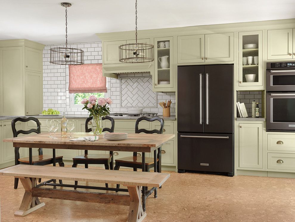 Eat-in kitchen - mid-sized country l-shaped cork floor and gray floor eat-in kitchen idea in St Louis with a farmhouse sink, shaker cabinets, gray cabinets, concrete countertops, black appliances, white backsplash, ceramic backsplash and gray countertops