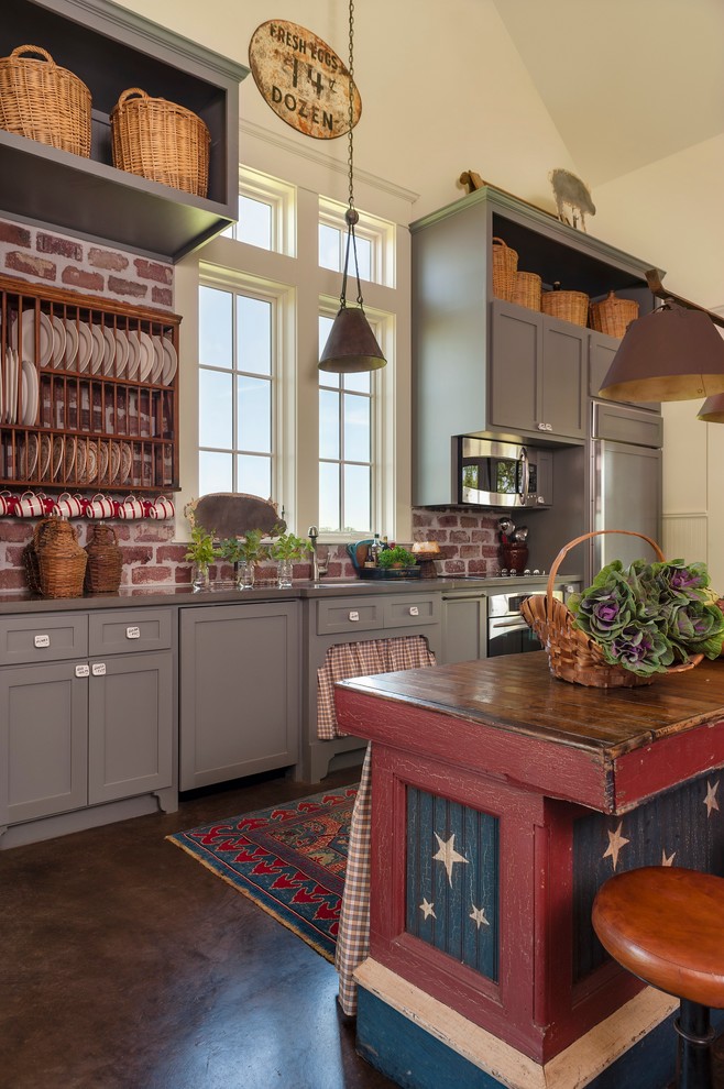 Cottage single-wall concrete floor kitchen photo in Houston with shaker cabinets, gray cabinets, red backsplash, stainless steel appliances, an island and wood countertops