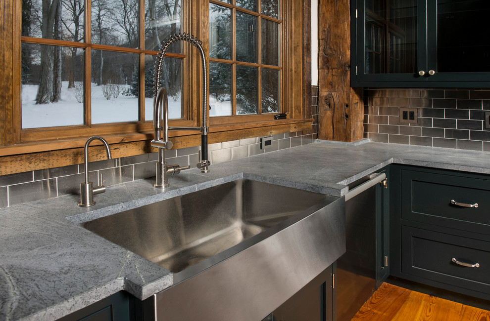 Enclosed kitchen - large rustic u-shaped light wood floor enclosed kitchen idea in New York with a farmhouse sink, beaded inset cabinets, green cabinets, soapstone countertops, metallic backsplash, metal backsplash and stainless steel appliances