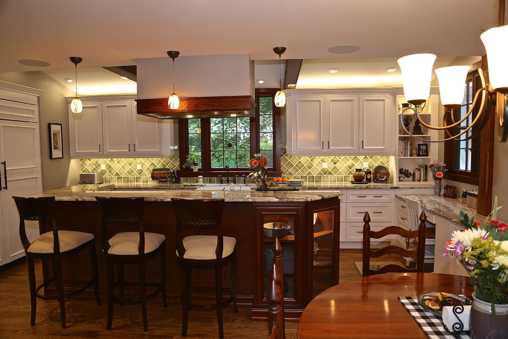 Inspiration for a mid-sized cottage medium tone wood floor kitchen pantry remodel in Philadelphia with a farmhouse sink, recessed-panel cabinets, white cabinets, granite countertops, green backsplash, ceramic backsplash, stainless steel appliances and an island