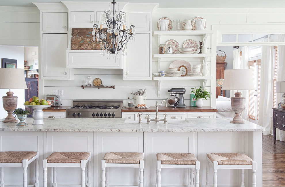 Inspiration for a cottage kitchen remodel in Atlanta with white cabinets and wood countertops