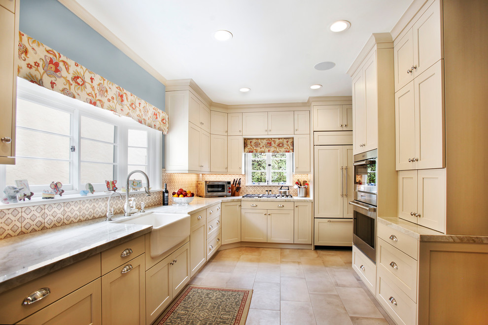 Inspiration for a medium sized country l-shaped enclosed kitchen in Los Angeles with a belfast sink, shaker cabinets, white cabinets, stainless steel appliances and no island.