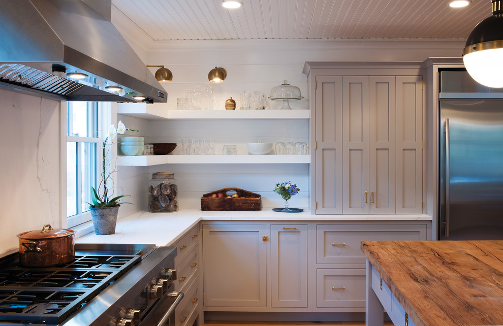 Kitchen - cottage u-shaped light wood floor kitchen idea in Boston with flat-panel cabinets, gray cabinets, white backsplash, stainless steel appliances and an island