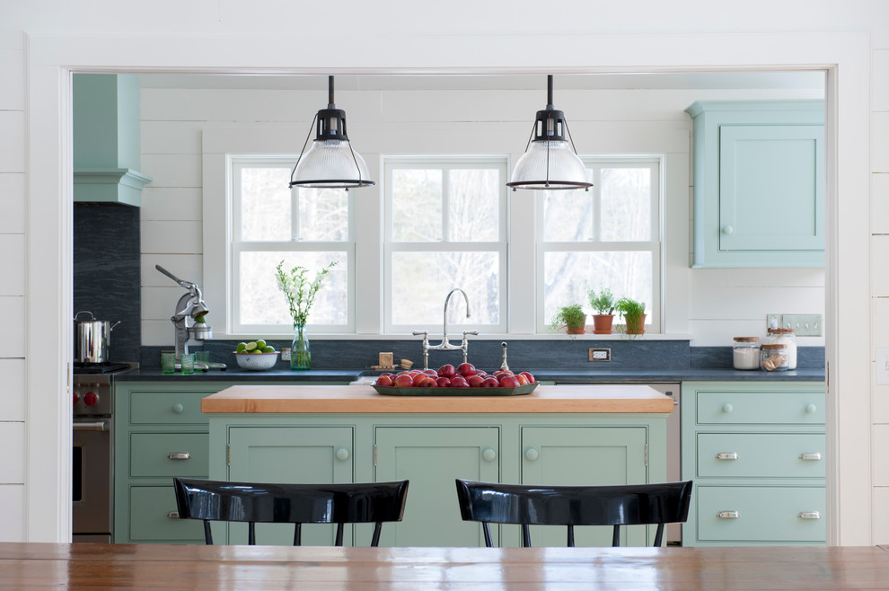 Example of a mid-sized cottage galley eat-in kitchen design in New York with beaded inset cabinets, blue cabinets, soapstone countertops, stainless steel appliances and an island
