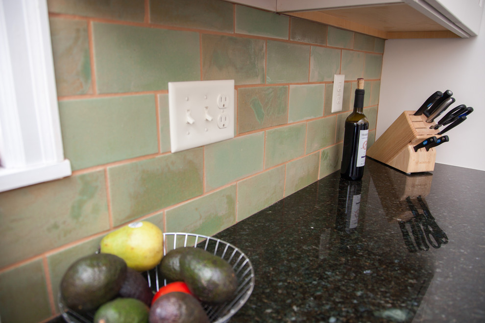 Enclosed kitchen - large farmhouse galley ceramic tile enclosed kitchen idea in Minneapolis with an undermount sink, recessed-panel cabinets, white cabinets, green backsplash, subway tile backsplash, stainless steel appliances, no island and granite countertops