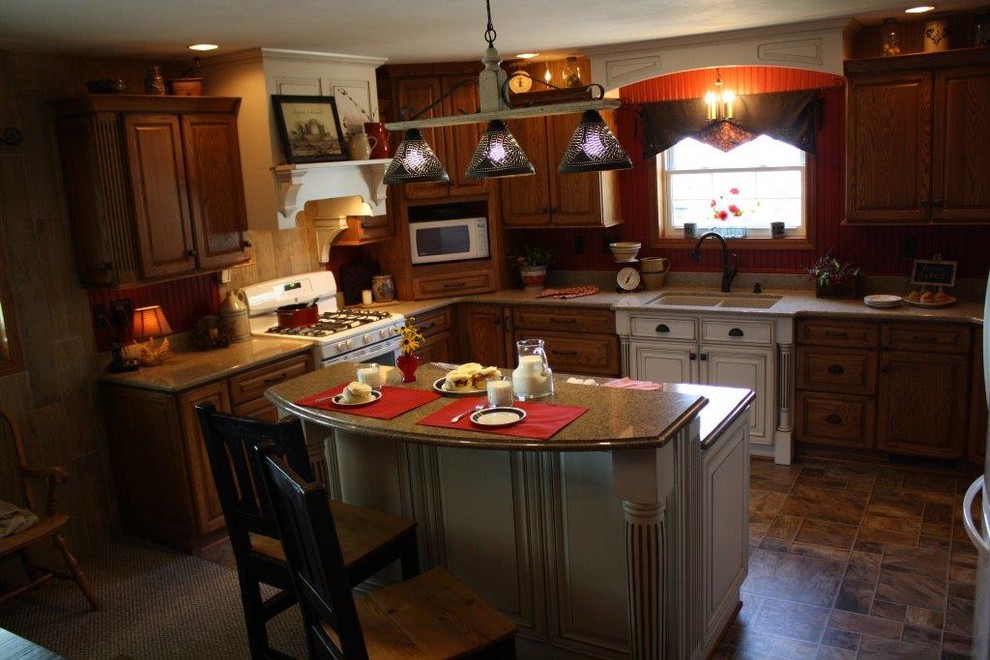 Immagine di una piccola cucina country con lavello sottopiano, ante con bugna sagomata, ante in legno scuro, top in granito, paraspruzzi rosso, paraspruzzi in legno, elettrodomestici bianchi e pavimento in vinile