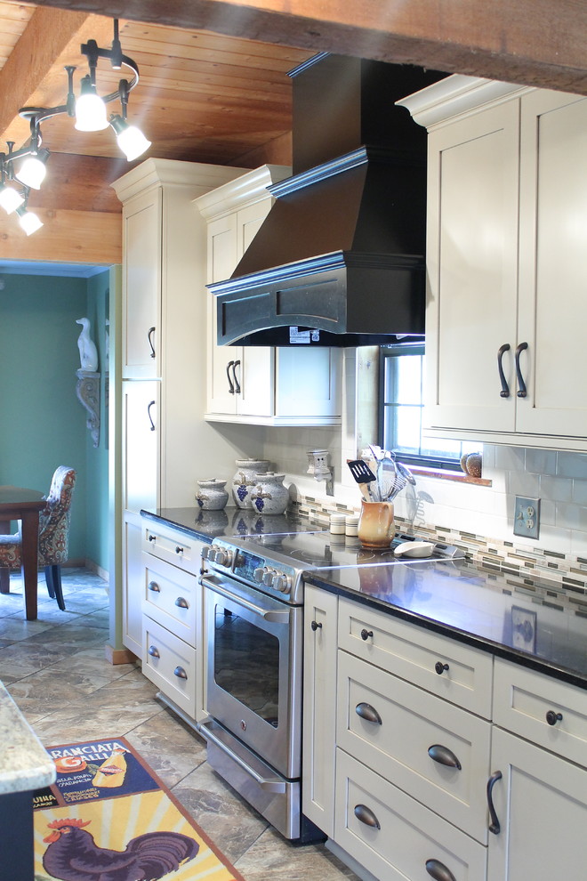 Mid-sized country porcelain tile eat-in kitchen photo in Other with a farmhouse sink, shaker cabinets, beige cabinets, granite countertops and an island
