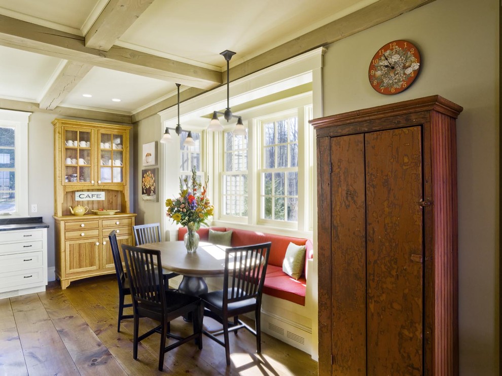 Example of a farmhouse eat-in kitchen design in Burlington with white cabinets