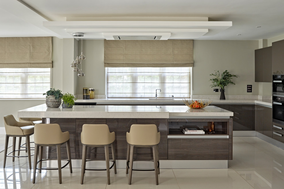 Photo of a large contemporary l-shaped kitchen in London with flat-panel cabinets, brown cabinets, white splashback, an island, beige floors and white worktops.