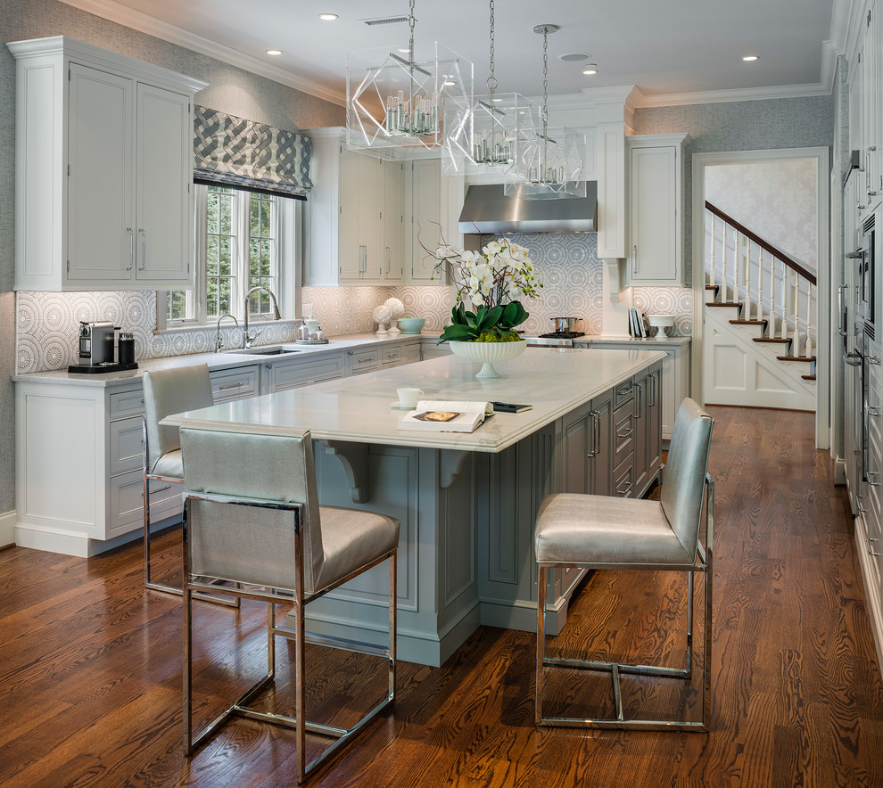 Photo of a large classic u-shaped kitchen in Philadelphia with grey cabinets, stainless steel appliances, an island, grey worktops, a submerged sink, beaded cabinets, grey splashback, dark hardwood flooring and brown floors.