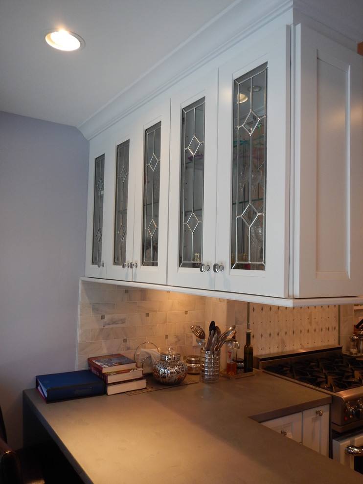 Example of a large trendy kitchen design in New York with shaker cabinets, white cabinets, concrete countertops and stainless steel appliances