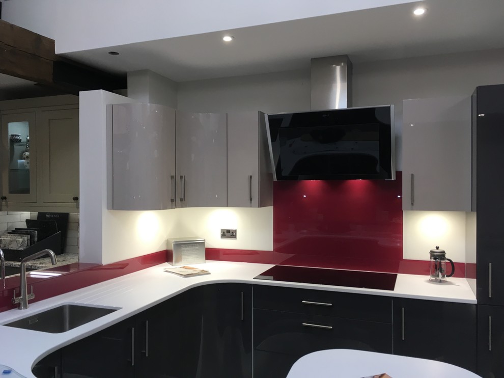 Mittelgroße Moderne Küche mit Küchenrückwand in Rot und Glasrückwand in Cheshire