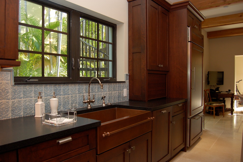 Example of a large classic eat-in kitchen design in Miami with a farmhouse sink, shaker cabinets, dark wood cabinets, paneled appliances and an island