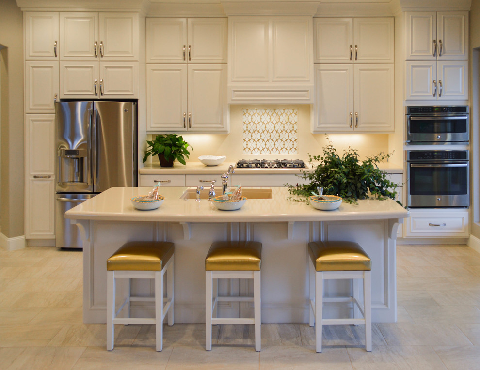 Mid-sized trendy single-wall porcelain tile kitchen photo in Salt Lake City with a single-bowl sink, raised-panel cabinets, white cabinets, solid surface countertops, stainless steel appliances and an island