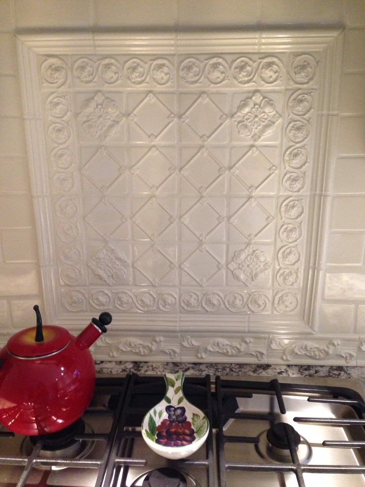 Example of a farmhouse kitchen design in New York with granite countertops, white backsplash and ceramic backsplash