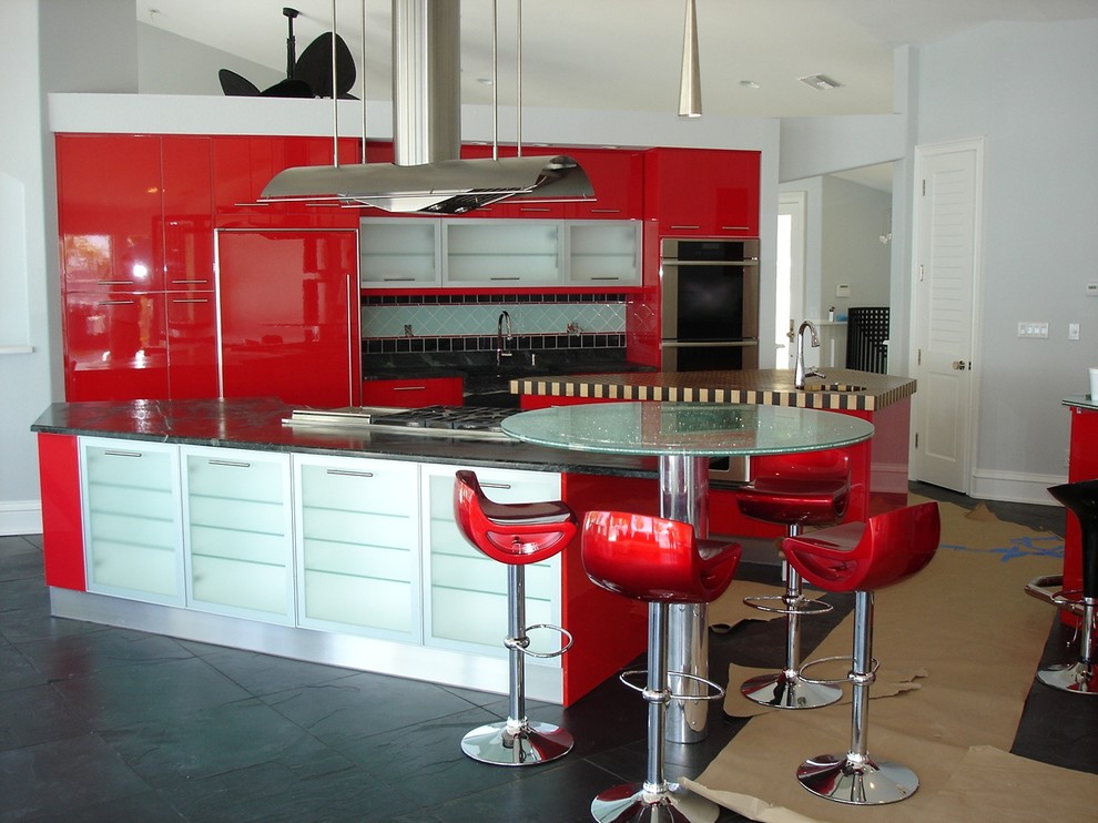 Large trendy eat-in kitchen photo in Miami with flat-panel cabinets, red cabinets, soapstone countertops and two islands