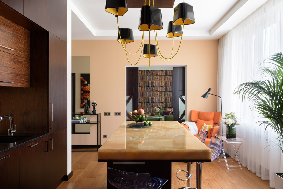This is an example of a medium sized contemporary kitchen/diner in Other with flat-panel cabinets, dark wood cabinets, onyx worktops, yellow splashback, medium hardwood flooring, an island, beige floors and yellow worktops.