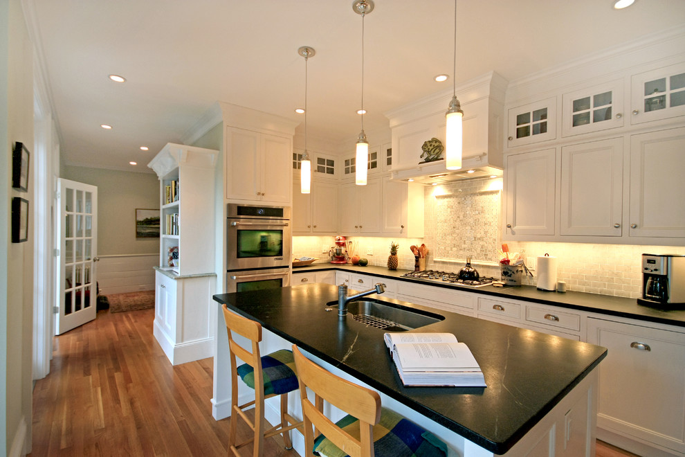 This is an example of a traditional kitchen in Boston with recessed-panel cabinets.