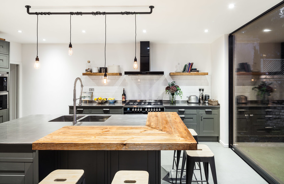 Photo of a contemporary kitchen in London with a double-bowl sink, medium wood cabinets, wood worktops, stainless steel appliances and an island.