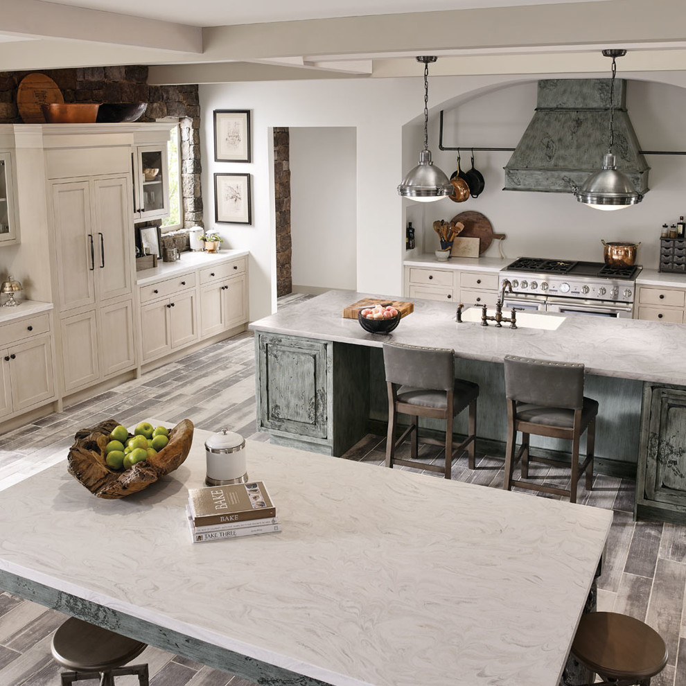 Design ideas for an expansive farmhouse l-shaped kitchen/diner in Other with a submerged sink, grey cabinets, stainless steel appliances, multiple islands, grey floors and recessed-panel cabinets.